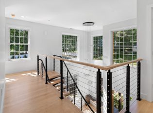 Cable railing system on upper level with views to the rooms below.