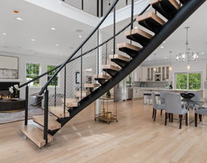 Center Entrance Curved Floating Stairs in open concept living space.