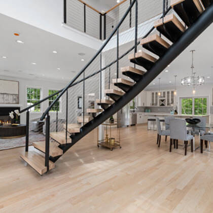 Center Entrance Curved Floating Stairs in open concept living space.