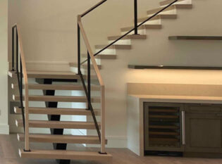 Interior floating stair combined with closed stair and framed glass railings