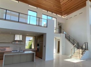 Glass balcony and modern glass stair railing in open concept home