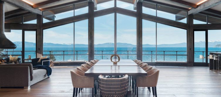 Mountain view as seen from great room of home on Lake Tahoe, through the expansive windows with Keuka Studios cable railings wrapping the decks