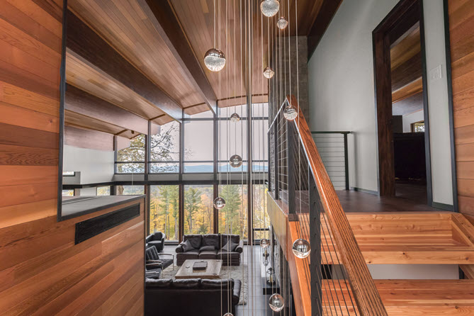 Black cable railing on rustic wood stairs with modern aesthetic and massive mountain views
