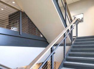 Interior office staircase with ADA handrails