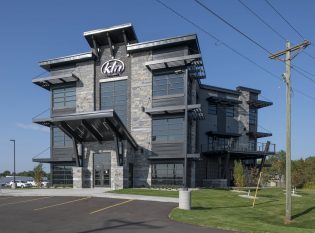 Exterior of KLN building with cable railing system on decks.