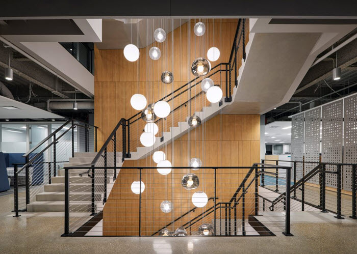 Cable railing on multi story staircase with ADA handrail and bubble lighting