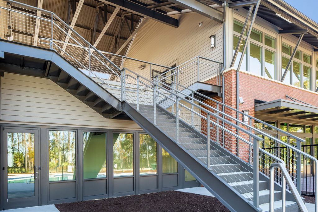 Grand exterior split staircase with cable railings and ADA handrails