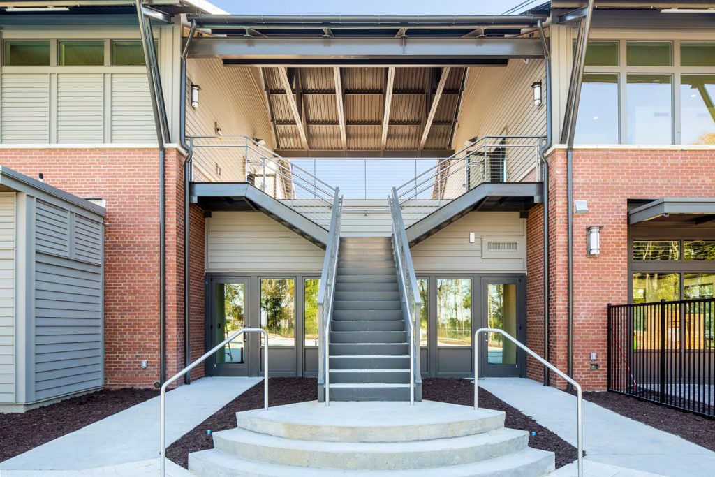 Grand commercial split staircase (bifurcated) entry with cable railing system