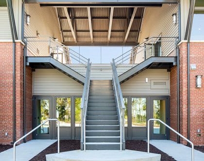 Split Staircase with cable railing system on modern waterfront facility