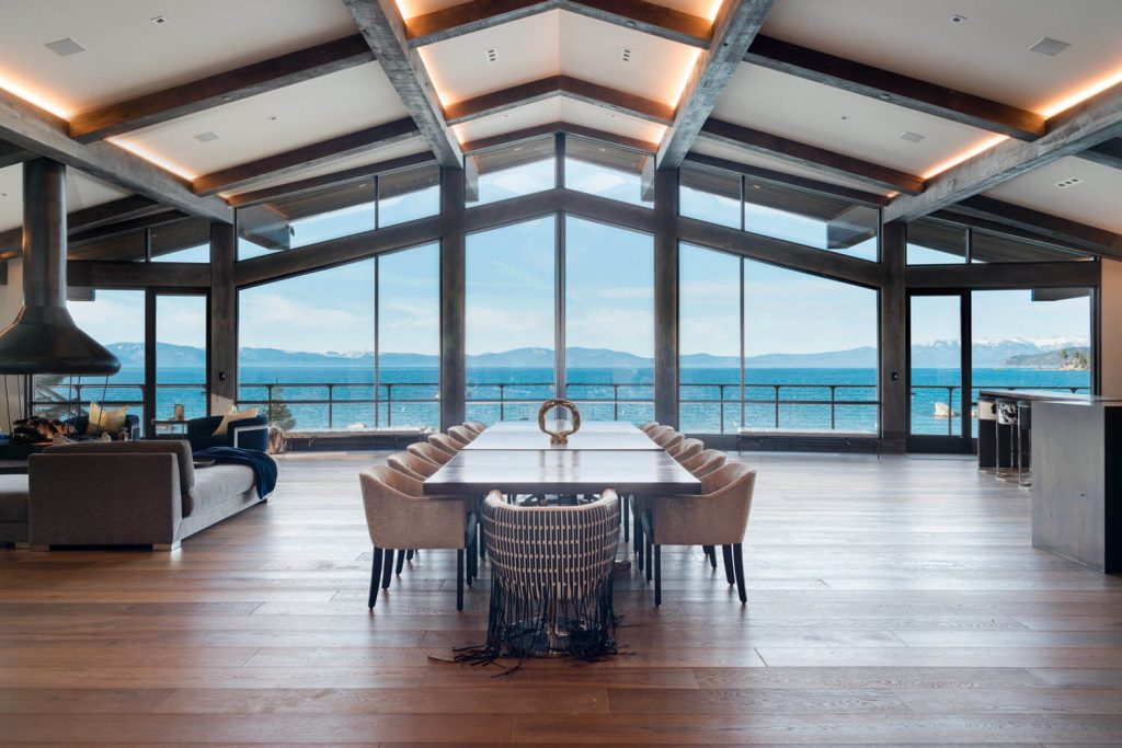 Expansive modern dining room with views of Lake Tahoe through the Keuka curved wire rope railings.