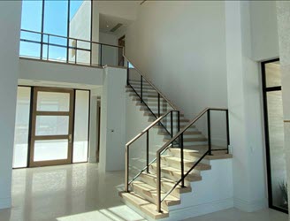 Framed glass railing on stairs and balcony of modern home