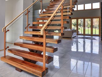 Glass railing on grand entry stairs with posts, glass clamps, and stringer powder coated to match