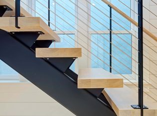 Close up of side view of stair stringer and cable railings.