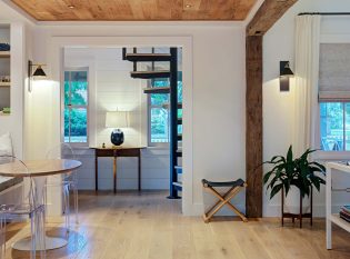 Living room with spiral stair in the entry hall.