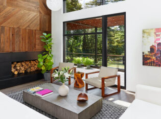 Cozy living room with view of deck and horizontal round bar railing.