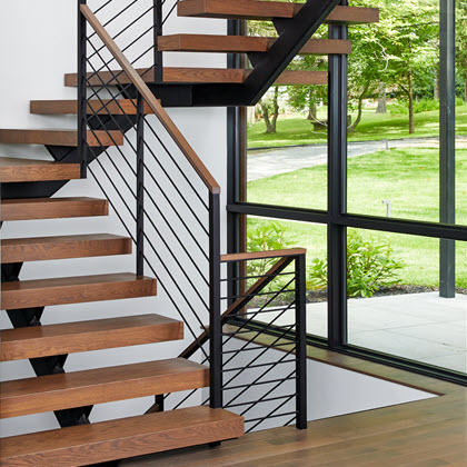 Horizontal Round Bar railing on floating stairs with wood treads