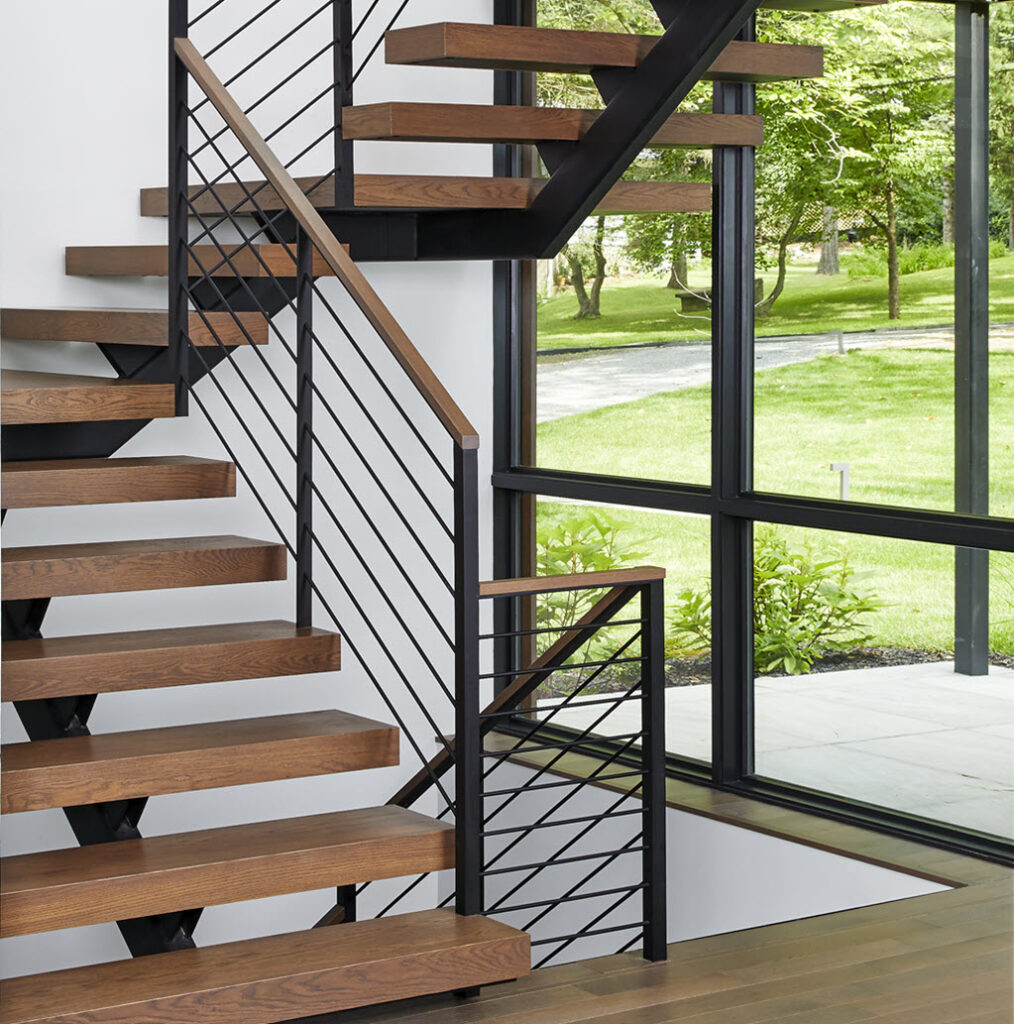 Modern floating staircase with horizontal rod railing and wood treads.