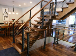 Center entry stairs with open risers and cable railings