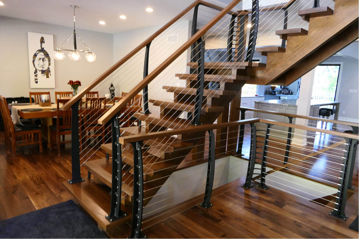 Center entry stairs with open risers and cable railings