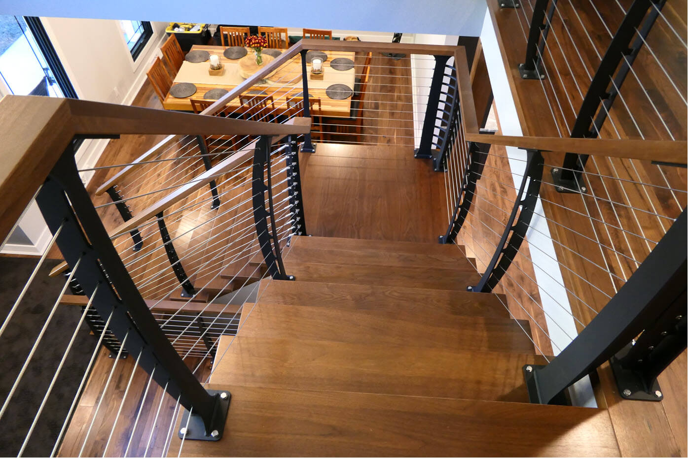Curved cable railing system on center staircaase