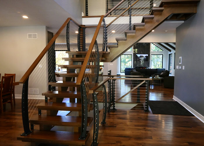Curved Cable Railings on open wood stringer stairs.