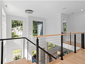 Balcony with slim cable railing overlooking entry and windows