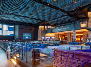 Viewing area of sportsbook theater with seating and dining