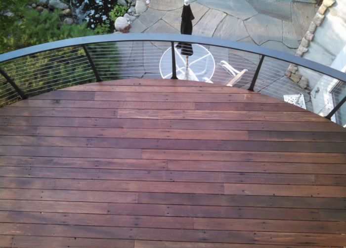 curved deck with fascia mounted cable railing looking to lower patio level