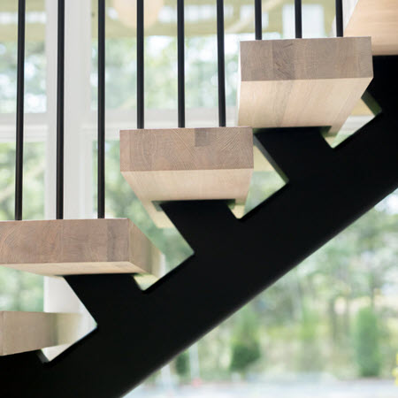 Close up view of white oak treads on floating stairs