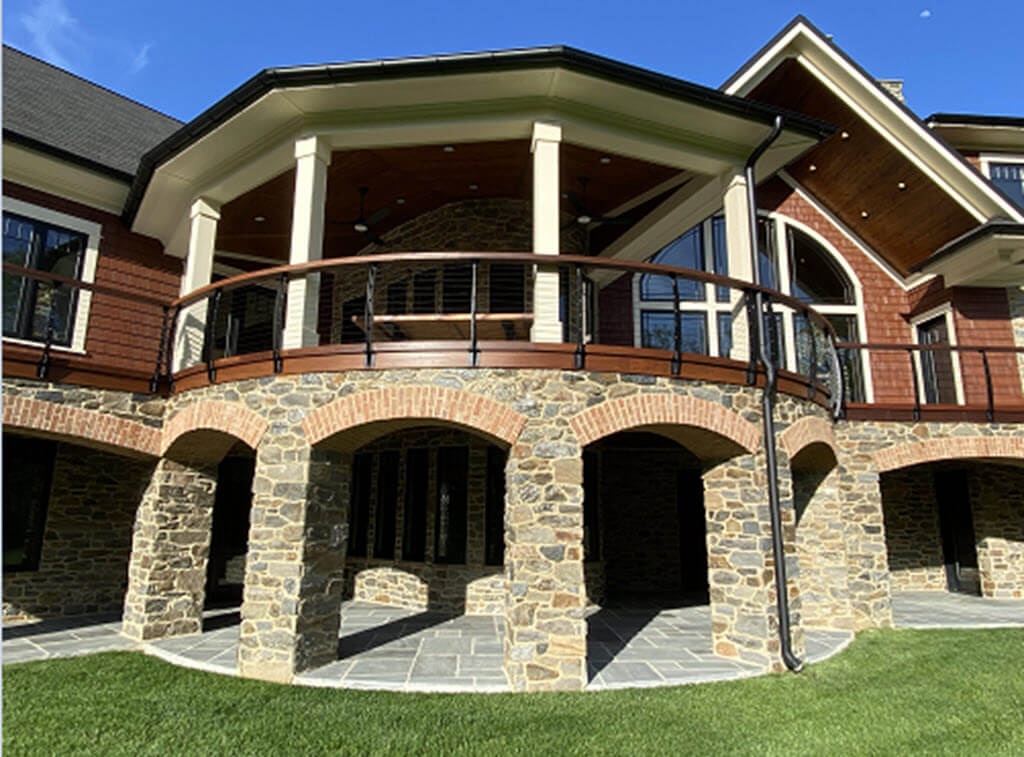 Stone Arches below Fascia Mounted Curved Cable Railing System