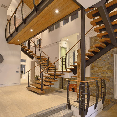 Grand entry double staircase made with rectangular tube mono stringer and wood treads.