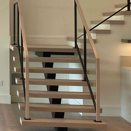 Floating stairs with square tube stringer and wood treads, with a glass raiing.