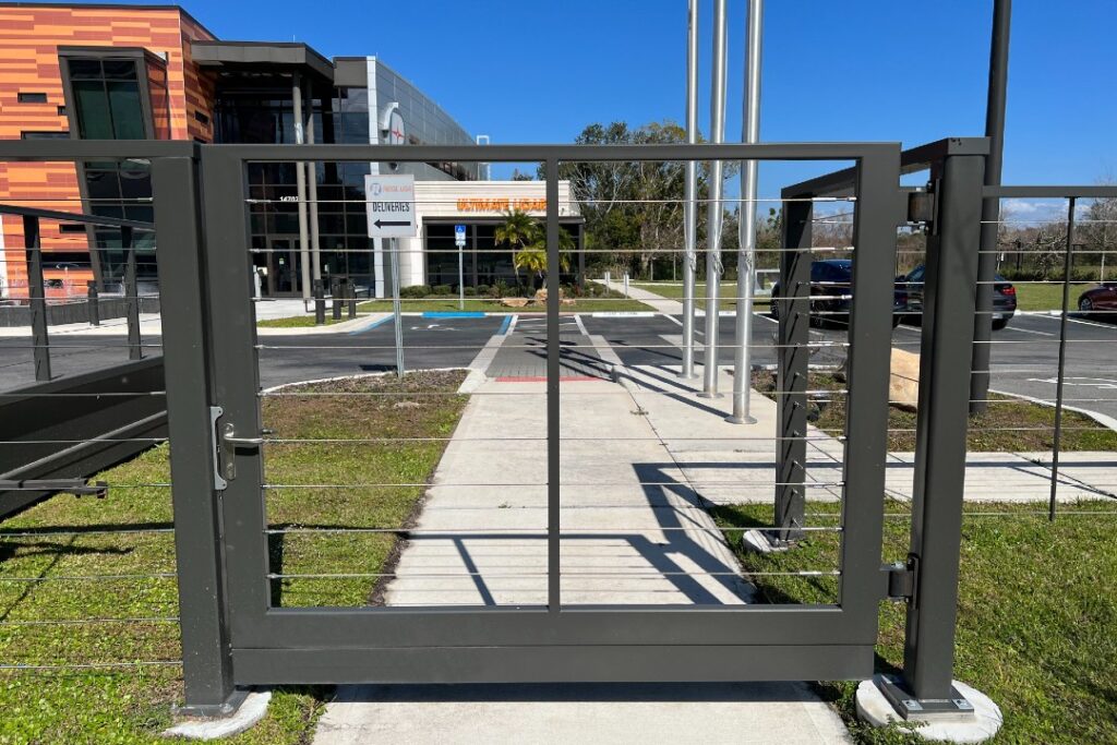 Pedestrian gate on corporate office entrance with cable infill.