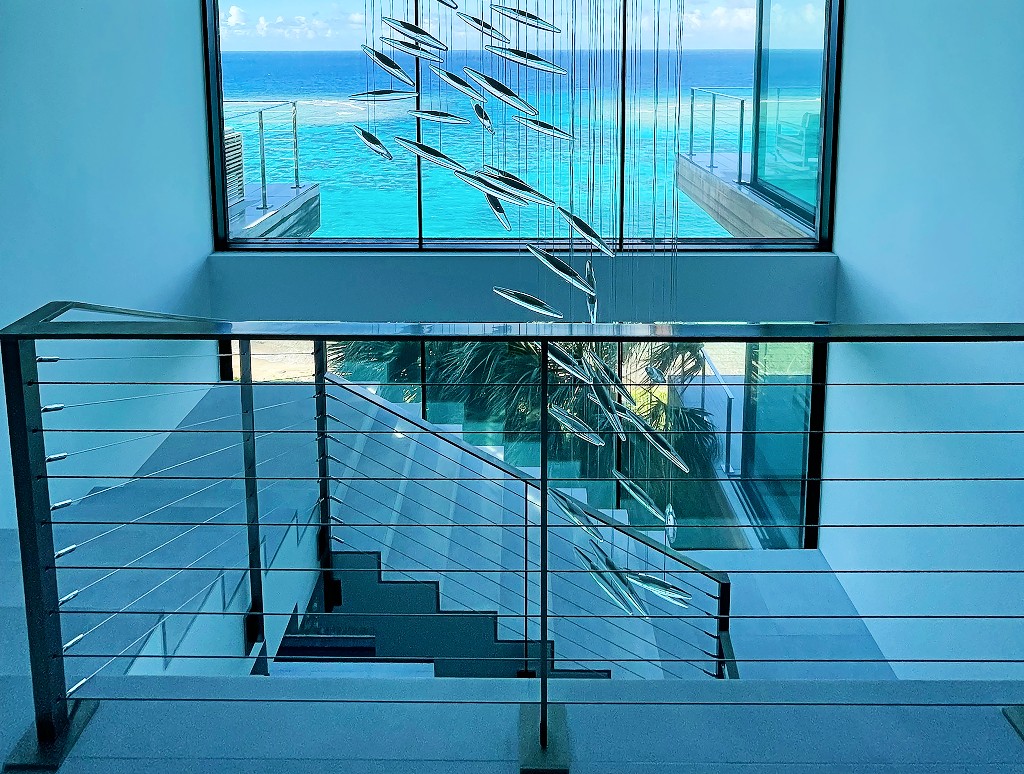 Mirror polished stainless steel cable railing on balcony, stairs and decks in an ocean front setting