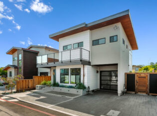 Modern home exterior with fascia mounted cable and glass railing.