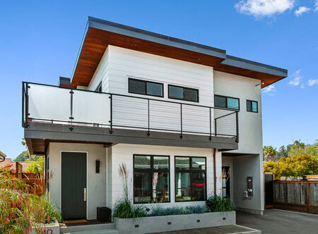Modern California home exterior with upper level balcoy that showcases a frosted glass and cable railing.