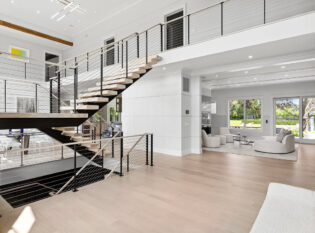 Interior floating stairs and landing with cable railings on two story home
