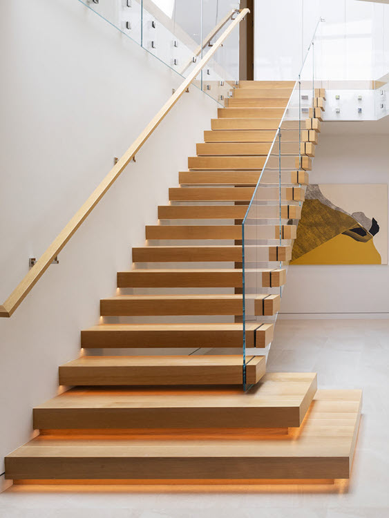 Cantilever Stair with wood treads and glass railings featurign LED lighting