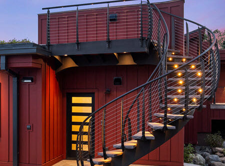 Exterior Curved Floating staircase with cable railings, brownstone steps and cable railings.