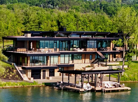 Modern Lake House featuring expansive decks stairs to the beach and a private dock. The decks, stairs and dock have our Ithaca style cable railing