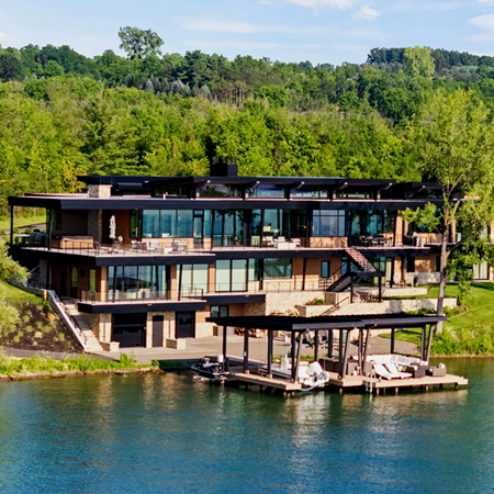 Modern Lake House featuring expansive decks stairs to the beach and a private dock. The decks, stairs and dock have our Ithaca style cable railing