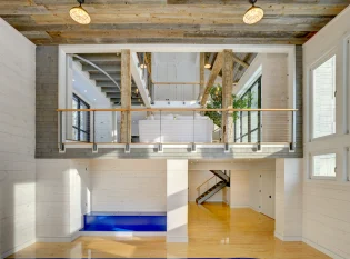 Indoor basketball court and reclaimed wood ceilings with keuka cable railing overlook
