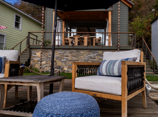 Cable railings on deck with stone facade