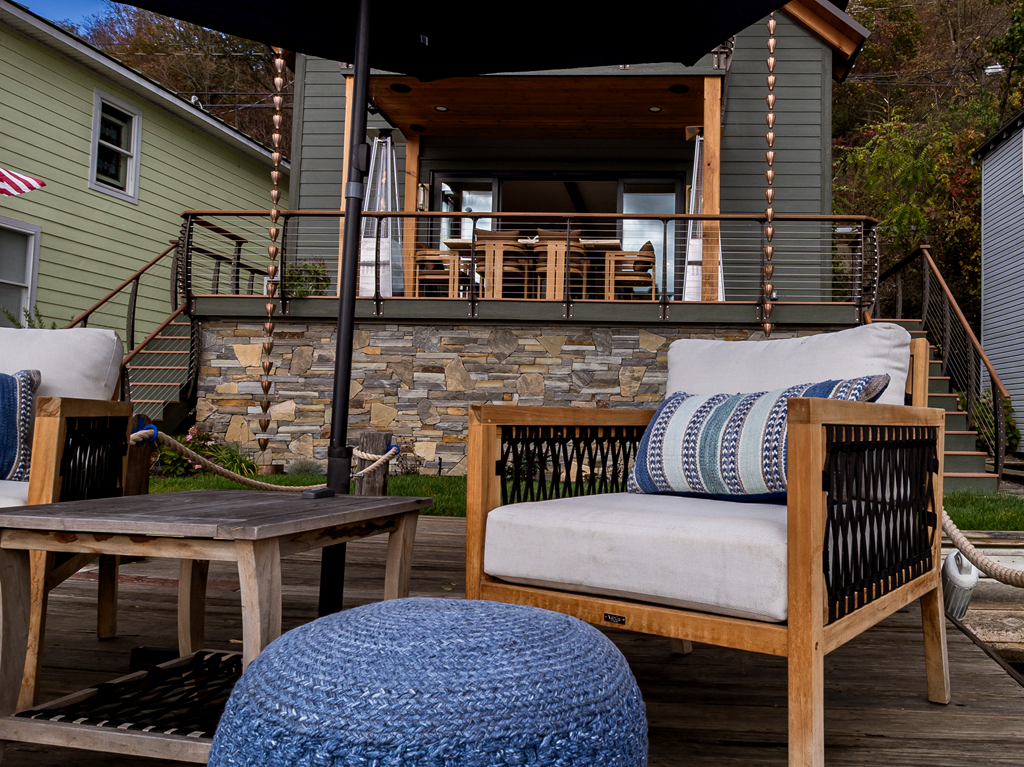 Cable railings on deck with stone facade