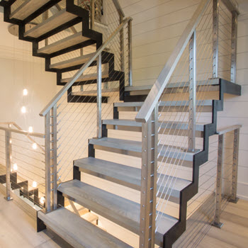 Zig zag stringer stairs with open risers and stainless steel cable railings