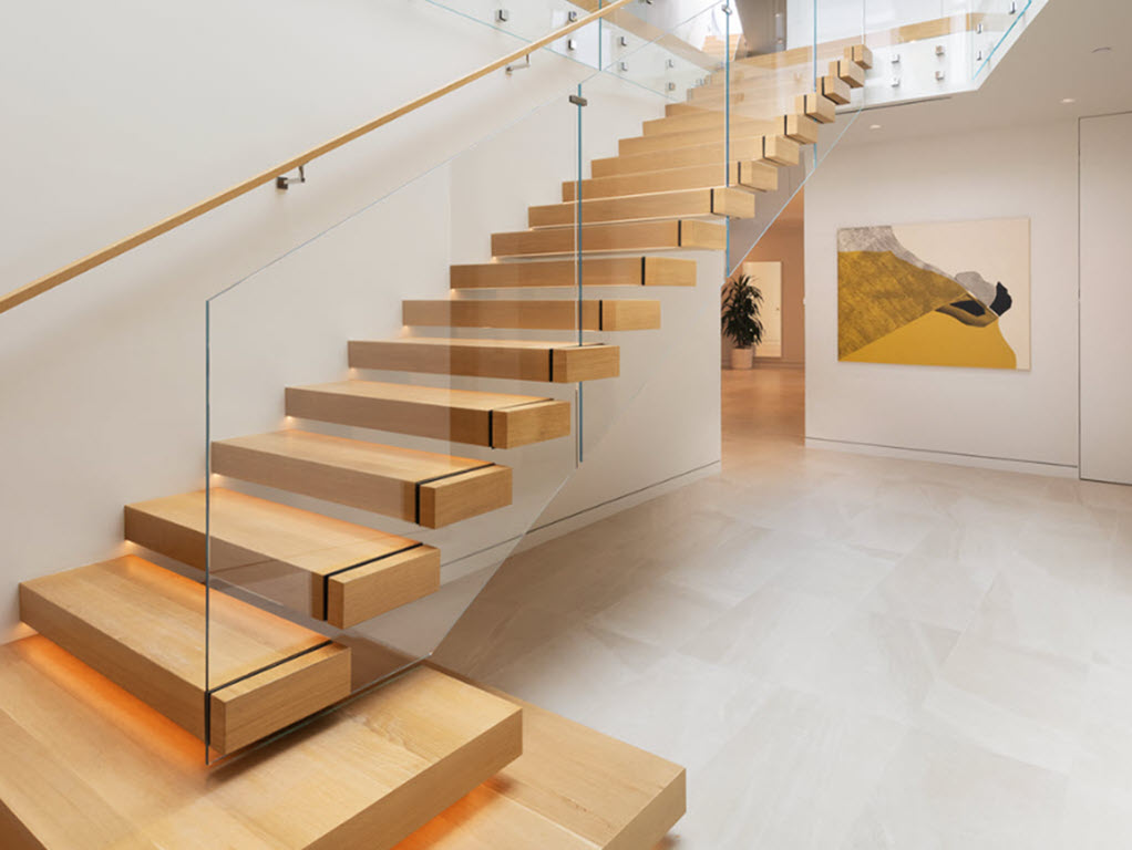 Modern interior cantilever stair with glass designed to elevate the aesthetic, maintain transparency and openness of the room.railing 