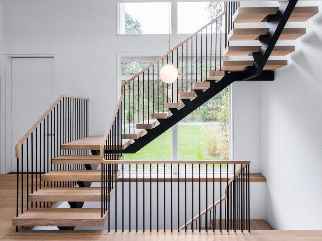 Custom Floating Stairs with vertical metal spindle railing designed to complement modern architecture.