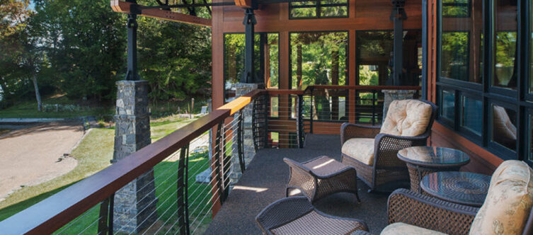 Curved cable railings on a modern home with plush furniture.
