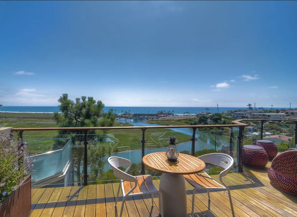Minimalist balcony with glass railing overlooking the ocean