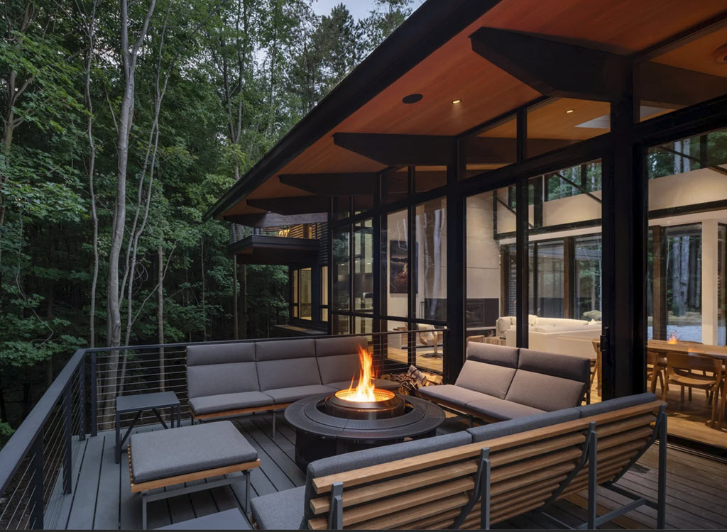 Balcony Design with outdoor lounge and plush furniture with fire feature.
